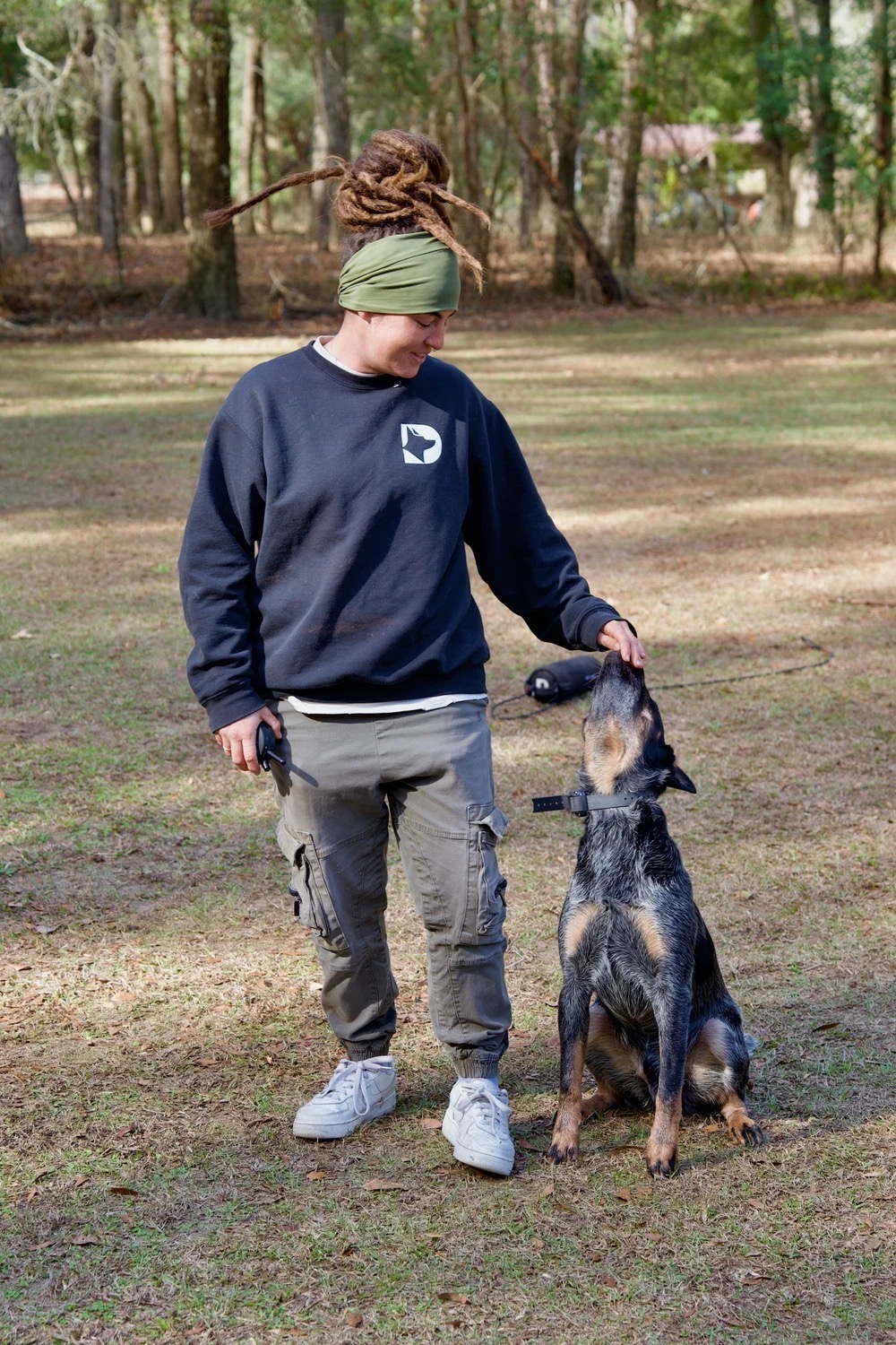 Gabriela working with a blue heeler in the field
